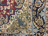 an antique persian rug with blue and red colors