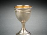a silver cup that is sitting on a table