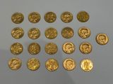 some gold coins are arranged in a circle on a white surface
