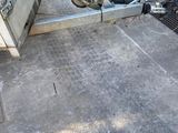 a scooter that is parked on the sidewalk next to a fence
