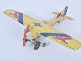 yellow and blue model of a small airplane on a white surface