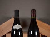 two bottles of wine sitting next to each other on a table