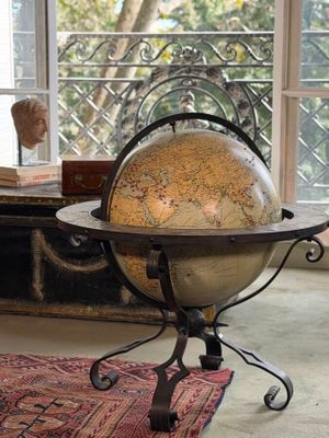 a table with a globe on it in front of a window