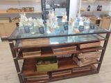 a glass table with bottles on top of it in a store