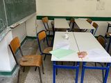 tables and chairs in a classroom with a chalkboard and a chalkboard on the wall