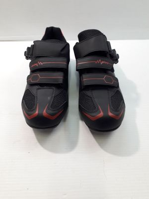 la paire de chaussures noires et rouges repose sur une surface blanche