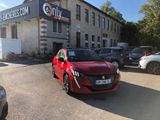 a red car parked in front of a building in a parking lot