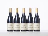 four bottles of red wine lined up in a row