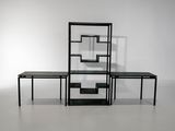 two tables and a shelf in the middle of a room