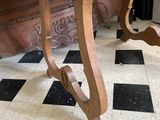 a wooden table that is on a black and white checkered floor