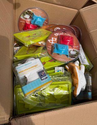 a cardboard box full of toys and other items