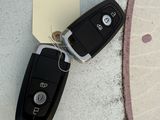 two car keys laying on a piece of paper