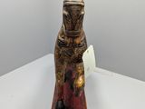 statue of a cat sitting on top of a wooden block