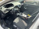 the interior of a white car with black seats and a steering wheel