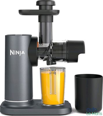 a juicer with a glass of orange juice next to it
