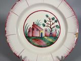 une assiette sur laquelle est représentée une maison