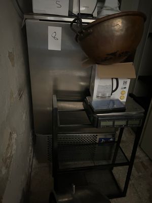 a metal cart with a bowl on top of it in a room