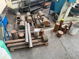 a pile of pipes sitting on the ground next to a machine