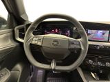 the interior of a car with a steering wheel and dashboard controls