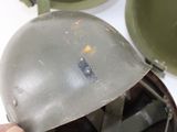 a person holding a helmet that has a hole in it