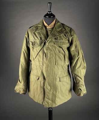 an olive green jacket on a mannequin mannequin mannequin mannequin mannequin mannequin mannequin mannequin manne