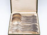 an assortment of silverware including forks and spoons in a case