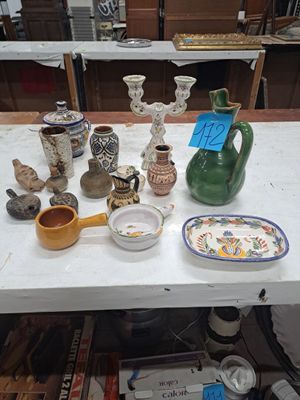 a table with a lot of vases and plates on it