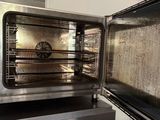 a silver oven that is open on the counter