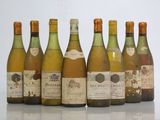 six bottles of wine are lined up in a row on a table