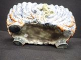 a ceramic hedge with a blue and white design on it