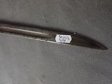 a knife with a tag on it sitting on a piece of cloth