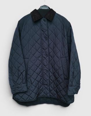 a close up of a jacket on a hanger on a wall
