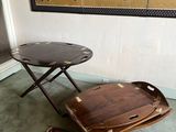 a small table with a tray on it in the corner of a room