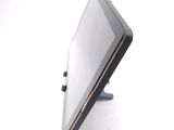 a tablet computer sitting on a stand on a white surface