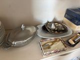 a shelf with plates, bowls, and other items on it