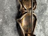 a metal bug that is sitting on top of a piece of cloth