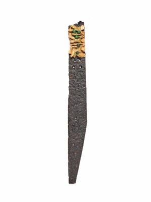 an image of a knife with a piece of wood sticking out of it