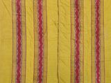 an old yellow and red striped cloth with red and white stripes