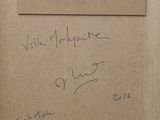 a piece of cardboard with writing on it and a piece of paper with writing on it