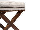 an image of a small stool with a blanket on top of it