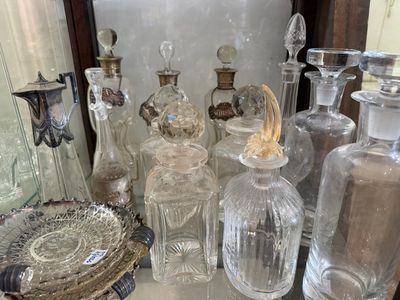 a lot of glass bottles sitting on a table