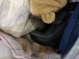 a teddy bear that is sitting in a pile of clothes