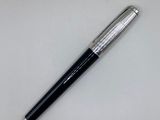 a close up of a pen on a table with a white background