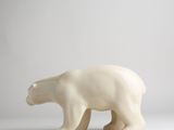 a white polar bear figurine standing on a white surface