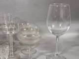 a lot of wine glasses that are sitting on a table