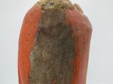 a vase that has a red and brown design on it