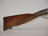 an old rifle with a wooden barrel on a white background