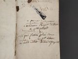 an old book with writing on it sitting on top of a table