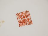 a close up of a white plate with red writing on it