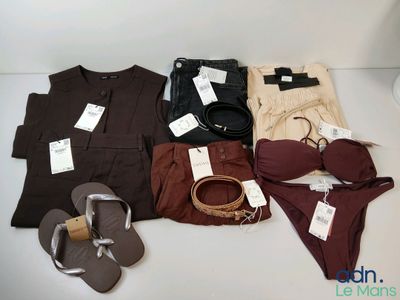 many different types of clothes and shoes on the table